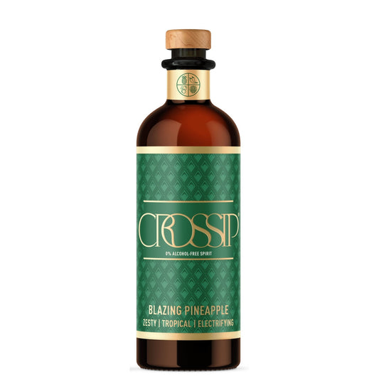 A bottle of CROSSIP Pineapple non-alcoholic spirit, featuring a dark green patterned label with gold lettering and a light brown wooden stopper, on a solid white background.