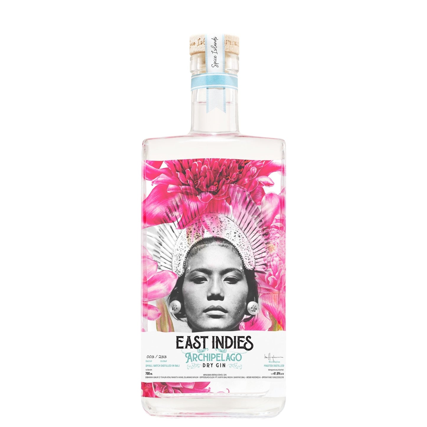 A bottle of East Indies 95% Chileño Dry Gin on a solid white background. The clear glass bottle features a vibrant label with a black-and-white portrait of a woman wearing a pink headdress, surrounded by bright pink flowers.