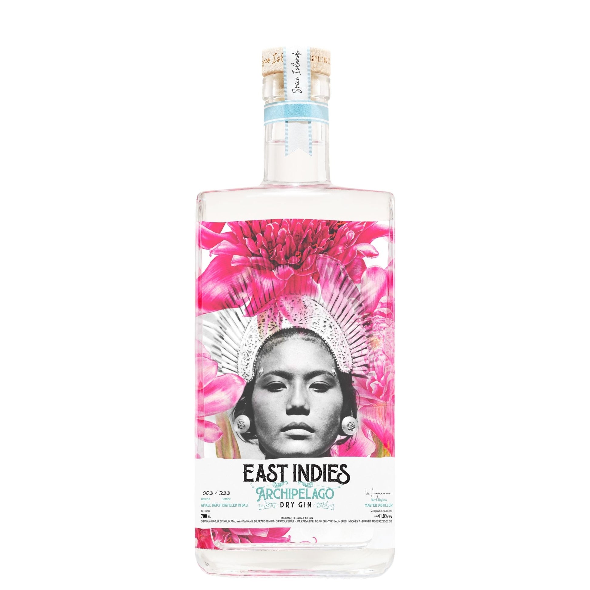 A bottle of East Indies 95% Chileño Dry Gin on a solid white background. The clear glass bottle features a vibrant label with a black-and-white portrait of a woman wearing a pink headdress, surrounded by bright pink flowers.
