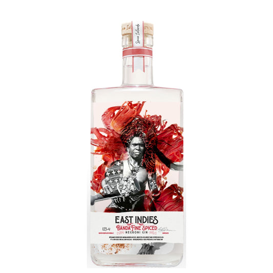 A clear glass bottle of East Indies Band of Fine Spiced Gin with a white label featuring a black-and-white portrait surrounded by bold red abstract floral shapes, on a plain white background.