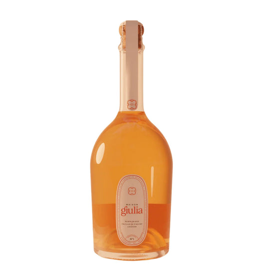 A bottle of Giulia sparkling wine with a pale peach-colored liquid, a light peach foil neck wrap, and a cream-colored oval label on a solid white background.