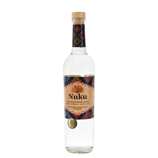 A clear glass bottle of Nuku ceremonial spirit with a light wood cap and a colorful geometric label, shown on a plain white background.