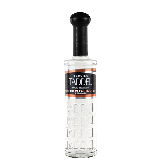 A bottle of TADDEL Cristalino tequila on a plain white background. The clear glass bottle features an embossed brand name and a black cap with a black and orange label.