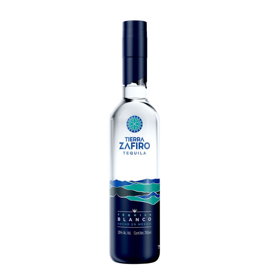 A 750ml bottle of Tierra Zafiro Tequila Blanco on a solid white background. The bottle is clear glass showing the liquid inside, with a dark navy blue cap and a matching dark blue label featuring a blue and green wave design.