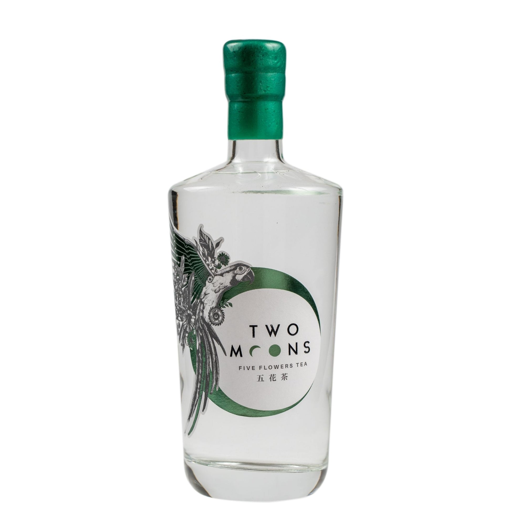 A clear glass bottle of Two Moons Five Flowers Tea with a metallic green cap and a green and white label featuring a bird illustration.