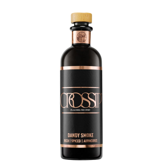 A bottle of CROSSIP Dandy Smoke 0% Alcohol Free Spirit. The bottle is dark brown glass with a black label featuring metallic rose gold text and borders, topped with a light wood cork stopper.